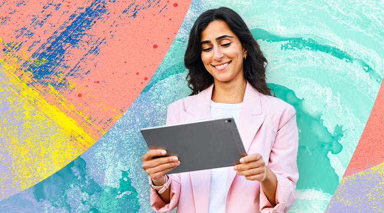 Person smiling while watching the Esri User Conference virtually on a tablet