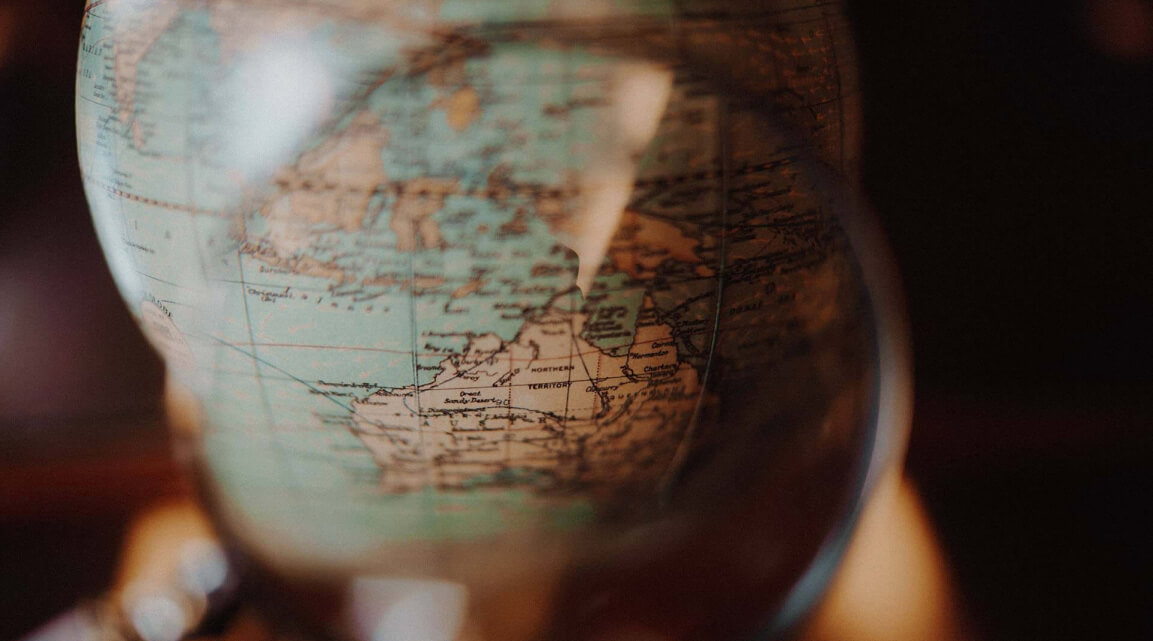Looking at a globe through a magnifying glass
