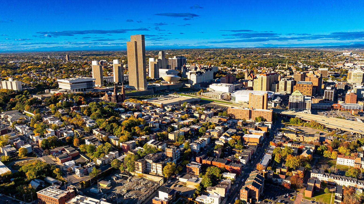 Photograph of a city with homes, parks, and tall buildings